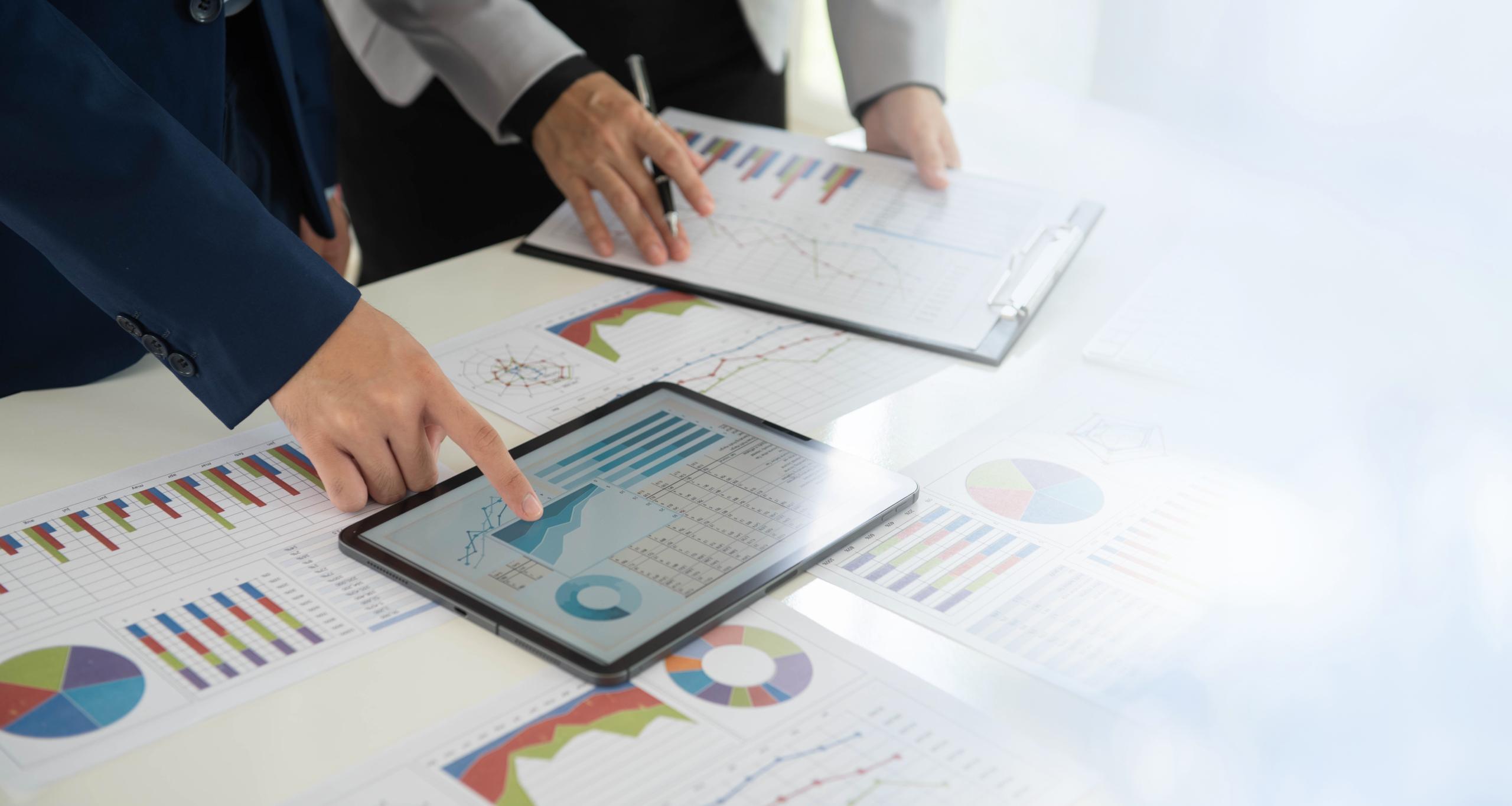 Businesspeople evaluate project efficiency and financial figures with business team for marketing research and business strategy plan.
