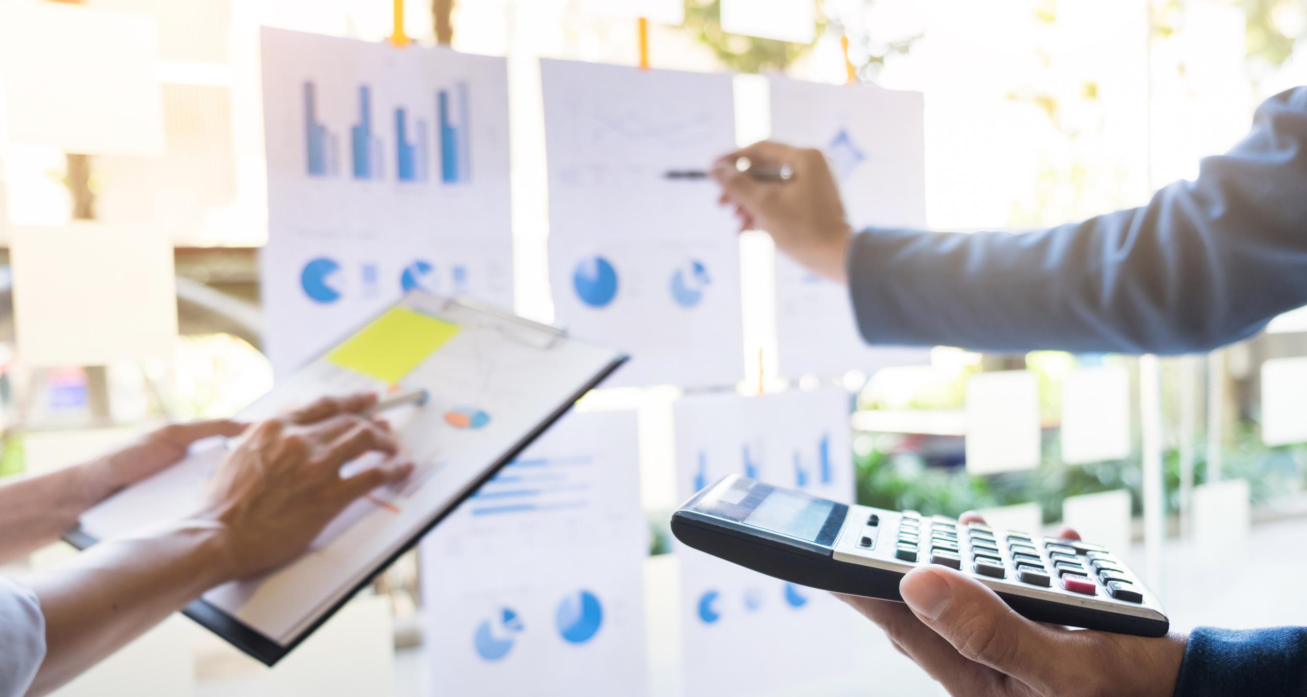 business man financial inspector and secretary making report, calculating or checking balance. Internal Revenue Service inspector checking document. Audit concept.